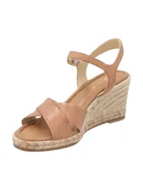 Sandalias de cuero color marrón tostado con plataforma de yute trenzado, tiras cruzadas en la parte delantera y tira ajustable al tobillo con hebilla metálica dorada.