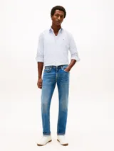 Pantalón de jean Tommy Hilfiger modelo Denton, de corte recto y color azul con efecto lavado. Presenta diseño clásico de cinco bolsillos, cierre de botón con cremallera y costuras reforzadas.