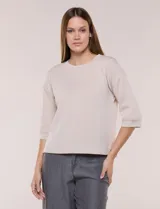 Buzo de calce relajado color beige, confeccionado en modal suave. Presenta cuello redondo clásico, mangas tres cuartos de hombros caídos con puño y ruedo recto.