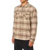 Camisa de franela de peso medio con estampado de cuadros en tonos beige y marrón. Presenta cuello clásico, cierre frontal con botones, dos bolsillos en el pecho con solapa y botón, y bajo redondeado.