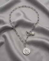 Collar de cadena de eslabones rectangulares de acero italiano, con cierre frontal de barra y argolla, decorado con una perla y un dije circular con la figura de un ángel.