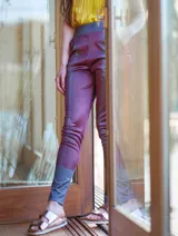 Pantalón de satén pintado a mano con diseño abstracto en tonos verde azulado y ocre.