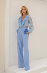 Blusa blanca traslúcida con escote en V y volados.