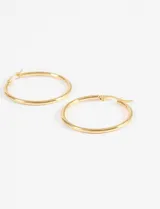 Aros tipo argolla de acero quirúrgico con acabado dorado, de diseño clásico y minimalista.