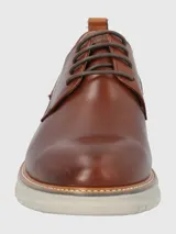 Zapato de vestir Hush Puppies modelo Rustic, confeccionado en cuero color marrón con cordones al tono. Presenta una suela de EVA en color gris claro con detalle de marca FLX en el lateral.