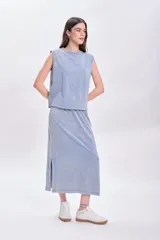 Falda midi celeste con efecto lavado, corte recto y abertura lateral.