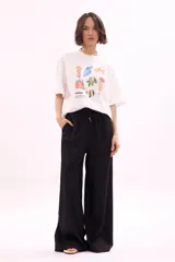 Remera blanca de manga corta, corte oversize, con estampa colorida de motivos marinos y botánicos en el frente.
