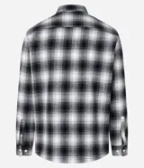 Camisa de franela a cuadros en blanco y negro, de corte comfort, con cuello inglés, abotonadura frontal, manga larga, bolsillo en el pecho y puños abotonados.