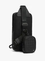 Cartera tipo sling Tommy Hilfiger de color negro, con diseño texturizado, bolsillo frontal con cierre y correa ajustable.