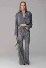 Pantalón jean de mujer tipo wide leg de tiro alto, color gris con diseño de tiras brillantes bordadas a lo largo de toda la prenda.
