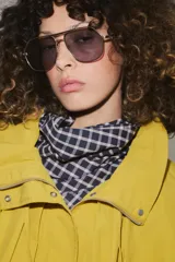 Cazadora bomber de cuello subido ajustable con cordones, manga larga con puños elásticos y cierre frontal con cremallera y botones a presión ocultos bajo solapa. Cuenta con bolsillos delanteros y diseño holgado.