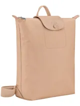 Mochila de diseño minimalista en color beige, con cierre superior de cremallera y solapa frontal con botón a presión. Presenta un asa superior y correas ajustables, con el logo de la marca grabado en la solapa.