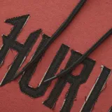 Buzo con capucha color ladrillo, con cordones negros y logo Hurley estampado en el frente.