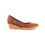 Zapato de cuero color marrón con taco chino revestido en corcho y detalles de yute trenzado en la plataforma. Presenta una abertura lateral y costuras pespunteadas.