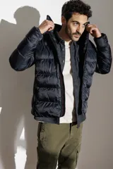 Campera puffer color verde militar, con cuello alto y cierre frontal.