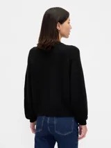Buzo de punto de algodón con cuello redondo, mangas largas con hombros caídos y puños y ruedo acanalados. Diseño de corte holgado.