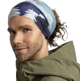 Cuello multifuncional Buff de la línea Thermonet, con diseño estampado de paisajes montañosos y árboles en tonos azul, verde, rosa y blanco. Fabricado con fibras aislantes PrimaLoft y tejido elástico sin costuras que gestiona la humedad.