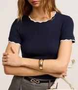 Top de manga corta, ajustado al cuerpo, color azul marino, con ribete de punto en contraste blanco con borde ondulado en el escote y los puños.