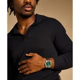 Reloj Fossil Machine con caja plateada de acero inoxidable, esfera verde con indicador de fecha y correa de cuero marrón.