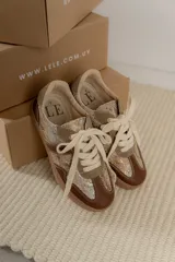 Championes urbanos de diseño acolchado, combinando tonos marrones, beige y detalles metalizados con textura. Cuentan con cordones al tono y suela de goma color caramelo.