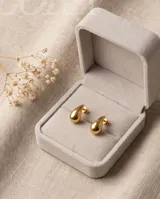 Caravanas de acero con baño de oro, con diseño minimalista en forma de gota.