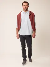 Pantalón de jean corte recto en color azul medio, con cierre de botón y cremallera, y bolsillos laterales y traseros.