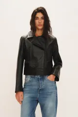 Campera biker de cuero de oveja en color negro, totalmente forrada. Cuenta con cuello con solapa, cierre cruzado, bolsillos frontales con cierre y un pequeño bolsillo con solapa y broche a presión.