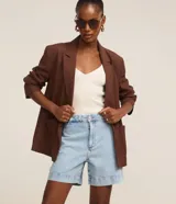 Short de jean tiro alto con trabillas y bolsillos, confeccionado en algodón denim azul con pespuntes contrastantes.