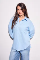Camisa oversize de lino y viscosa color celeste, con cuello clásico, cierre frontal con botones y mangas largas.