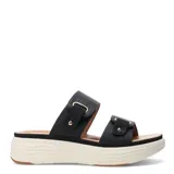 Sandalias de plataforma con dos tiras anchas ajustables mediante hebillas metálicas doradas. Presentan un diseño ergonómico con suela de goma texturizada en color crema y cuerpo en tono beige.