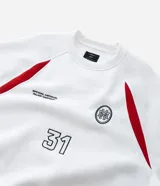 Saco deportivo boxy de algodón felpa color blanco, con cuello redondo, manga raglán larga y recortes rojos en los hombros. Presenta bordados frontales con texto "OFFICIAL NATIONAL MAJOR HARMONY", un logo circular y el número "31". Las mangas tienen un patrón de cuadros rojos y blancos.