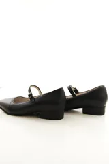 Zapato Mary Jane de cuero negro con punta cuadrada y tira del empeine ajustable con hebilla metálica.
