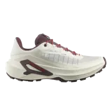 Championes de trail running Salomon Genesis 2, en color beige claro con detalles en bordó y rojo. Cuentan con capellada de Matryx®, sistema de ajuste rápido de cordones Quicklace, suela Contagrip® y tecnología Active Chassis para mayor estabilidad.