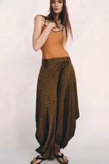 Pantalón de tiro medio confeccionado en viscosa, con diseño de pierna ancha y drapeado lateral. Presenta cintura con trabillas y cierre de cremallera oculto en la costura.