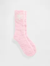 Medias de textura suave y afelpada en color rosado, con diseño de copo de nieve en la parte superior.
