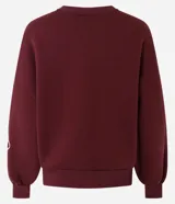 Buzo de algodón color bordó con cuello redondo acanalado, mangas largas con puños ajustados y terminación inferior elástica. Presenta un diseño de bordado floral en cuerda de color crudo en el frente y en una de las mangas.