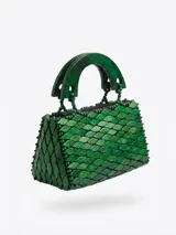 Cartera de mano tipo minibag revestida en piezas de madera verde con forma de escamas, asas rígidas de madera tallada y cierre superior.