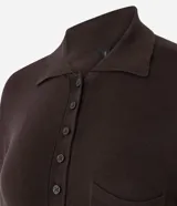Blusa de punto color bordó con cuello polo, cierre frontal parcial con botones y bolsillo pequeño aplicado en el pecho. Presenta mangas largas y un corte regular.