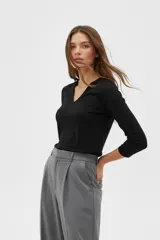 Remera de manga 3/4 con cuello en V, confeccionada en poliéster, de corte holgado.