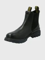 Bota tipo Chelsea de la marca Hush Puppies, confeccionada en cuero negro con paneles laterales elásticos y tiradores superiores con diseño gráfico en amarillo y negro. Presenta una suela de goma robusta y dentada con tecnología Fusion para mayor absorción de impactos.