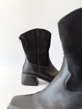 Botas texanas de cuero negro con caña media, puntera cuadrada y tacón bloque.