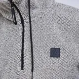 Canguro Volcom de tejido técnico bonded, color gris jaspeado, con capucha ajustable mediante cordones negros, cierre frontal parcial de cremallera y bolsillo tipo canguro delantero.