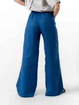 Pantalón de lino de corte holgado y tiro ajustable, con cintura elástica y cordón. Presenta bolsillos laterales y un bolsillo trasero.
