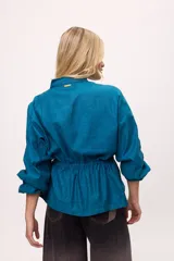 Chaqueta azul con cuello mao, mangas largas abullonadas y lazo en la cintura.