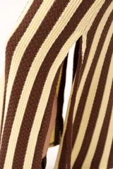 Pollera larga tejida a rayas verticales color chocolate y crema, con pretina elástica y tajos laterales.