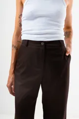 Pantalón de vestir color marrón oscuro, de corte recto y tiro medio, con diseño de pierna ancha.