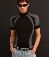 Remera negra ajustada al cuerpo, de cuello alto con cremallera y mangas cortas. Diseño seamless con estampa abstracta en tonos grises en hombros y laterales.