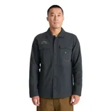 Campera tipo camisa de trabajo Roark, confeccionada en lona de algodón orgánico color gris oscuro. Presenta cierre frontal con botones a presión, dos bolsillos frontales con solapa, paneles reforzados en los codos y detalles bordados sutiles en el pecho y la manga.
