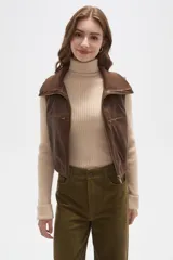 Chaleco cropped de eco-cuero color marrón, con cierre frontal, cuello solapa y bolsillos con cierre en el pecho.