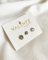 Set de tres pares de aros de acero plateado con diferentes diseños: huella de perro, ojo turco y árbol de la vida.